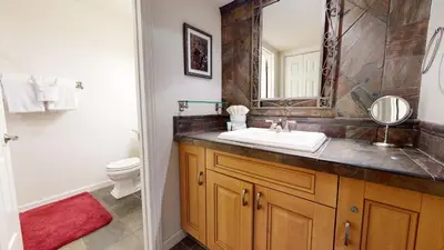 a bathroom with a sink and a toilet and a mirror at Mammoth Estates Studio Condos 2 Blocks from The Village Gondola Station in Mammoth Lakes
