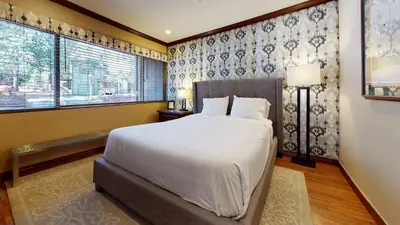 a bedroom with a large bed and a window at Mammoth Estates 4 Bedroom Condos - Great for Families! in Mammoth Lakes