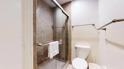a bathroom with a toilet and a glass shower at Mammoth Estates 4 Bedroom Condos - Great for Families! in Mammoth Lakes