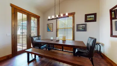 a dining room with a wooden table and black chairs at Snowcreek The Lodges #1127 condo in Mammoth Lakes