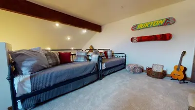 a bedroom with a bed and a guitar in a room at Snowcreek The Lodges #1127 condo in Mammoth Lakes