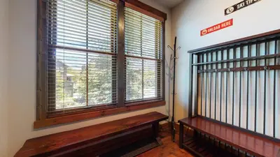 a room with a bench in front of a window at Snowcreek The Lodges #1127 condo in Mammoth Lakes