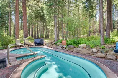 a swimming pool in a yard with trees at Northstar Gold Bend Retreat in Truckee