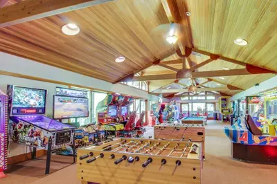 a room with several arcade games and tables at Northstar Gold Bend Retreat in Truckee