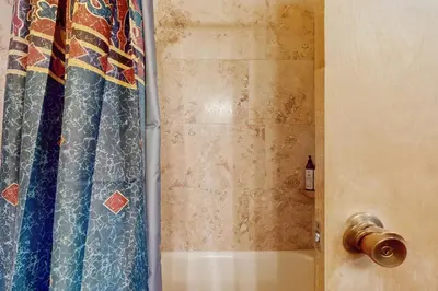 a bathroom with a shower with a shower curtain at Unit 18A at Granlibakken in Tahoe City