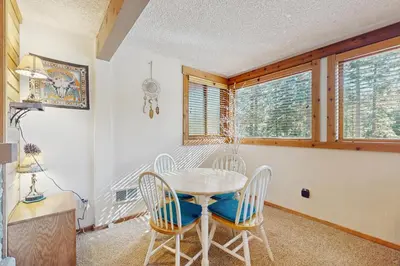 a dining room with a table and chairs at Unit 18A at Granlibakken in Tahoe City