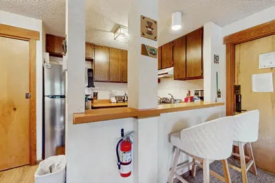 a kitchen with wooden cabinets and a refrigerator at Unit 18A at Granlibakken in Tahoe City