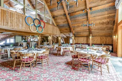 a dining room with tables and chairs with olympics signs at Unit 18A at Granlibakken in Tahoe City