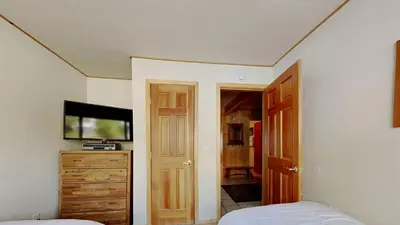 a bedroom with a bed and a dresser and a tv at 2 Bedroom Townhome With Easy Access to Mountain Biking & Lake Activities - Unit 531 at 1849 condo in Mammoth Lakes