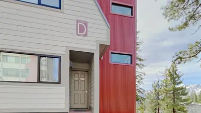 a red and white building with a door at 2 Bedroom Townhome With Easy Access to Mountain Biking & Lake Activities - Unit 531 at 1849 condo in Mammoth Lakes
