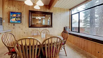 a dining room with a table and chairs and a window at 2 Bedroom Townhome With Easy Access to Mountain Biking & Lake Activities - Unit 531 at 1849 condo in Mammoth Lakes