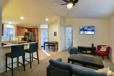 a living room with a couch a table and a kitchen at 3R Suter's Forte in North Wawona