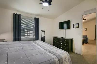 a bedroom with a bed and a tv and a dresser at 3R Suter's Forte in North Wawona