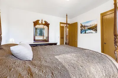 a bedroom with a large bed and a mirror at Mountain Springs Lodge in Groveland
