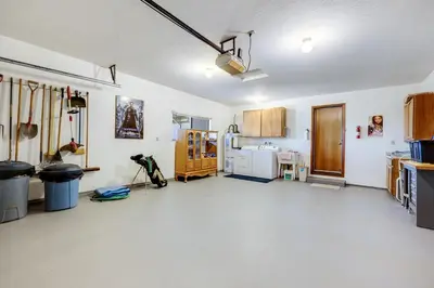 a large room with a kitchen with white floors at Mountain Springs Lodge in Groveland