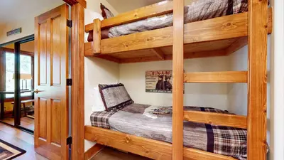 a bedroom with two bunk beds in a house at Snowcreek #13 condo in Mammoth Lakes
