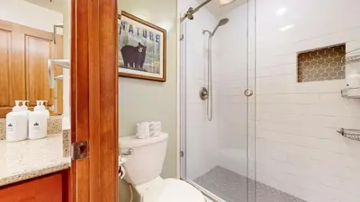 a bathroom with a toilet and a glass shower at Snowcreek #13 condo in Mammoth Lakes