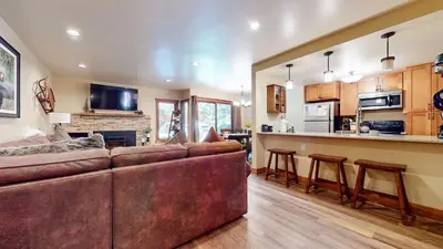 a living room with a couch and a kitchen at Snowcreek #13 condo in Mammoth Lakes