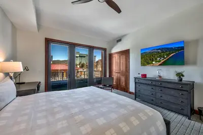 a bedroom with a bed and a dresser with a window at Luxury Three Bedroom Residence steps from Heavenly Village condo in South Lake Tahoe