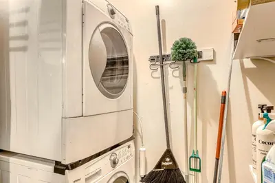 a washing machine in a kitchen with a broom at Echo Escape in South Lake Tahoe
