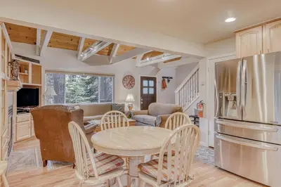 a kitchen and living room with a table and chairs at Echo Escape in South Lake Tahoe