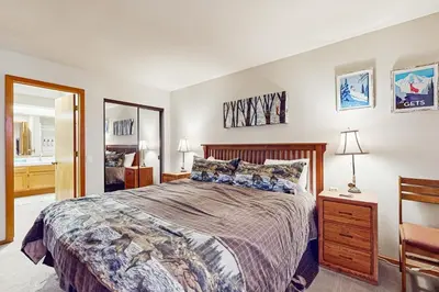 a bedroom with a large bed and a mirror at Snowcreek 607 in Mammoth Lakes