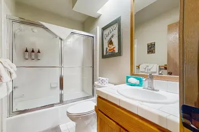 a bathroom with a shower and a toilet and a sink at Snowcreek 607 in Mammoth Lakes