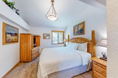 a bedroom with a large bed and a dresser at Summit 70 in Mammoth Lakes