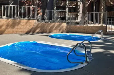 a small pool with blue water in a street at Summit 70 in Mammoth Lakes