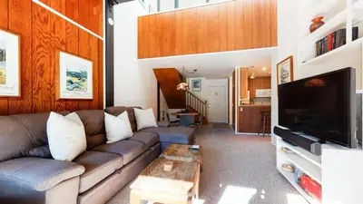 a living room with a couch and a tv at Summit #293 condo in Mammoth Lakes