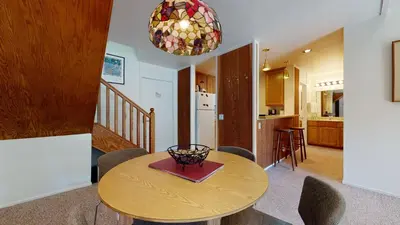 a kitchen and dining room with a table and chairs at Summit #293 condo in Mammoth Lakes
