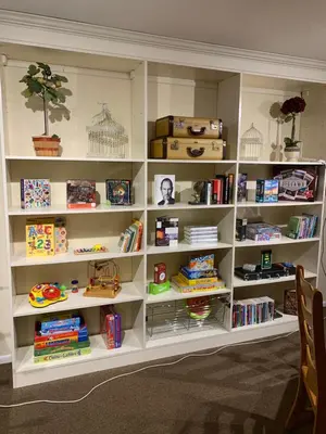 a white book shelf filled with lots of books at Villa Alta Vista at Yosemite- Stunning Views and Game Room in Mariposa
