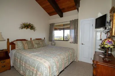 a bedroom with a bed and a tv on the wall at Mammoth Ski Racquet Club 55 in Mammoth Lakes