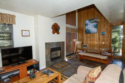a living room with a tv and a fireplace at Mammoth Ski Racquet Club 55 in Mammoth Lakes