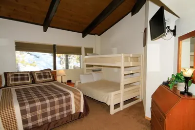 a bedroom with a bunk bed and a tv at Sierra Park Villas 29 in Mammoth Lakes