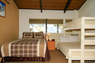 a bedroom with a bunk bed and a bunk ladder at Sierra Park Villas 29 in Mammoth Lakes