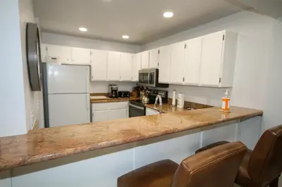 a kitchen with white cabinets and a counter top at Mammoth Ski Racquet Club 127 in Mammoth Lakes