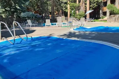 an empty pool with blue water in a park at Summit 80 in Mammoth Lakes