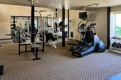 a gym with a bunch of equipment in a room at Summit 80 in Mammoth Lakes