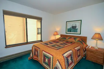 a bedroom with a large bed and a window at Discovery 4 150 Loft in Mammoth Lakes