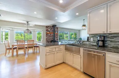 a kitchen with a table and a dining room at Spectacular Views w/ Hot Tub/BBQ -Yosemite & Bass Lake in Oakhurst