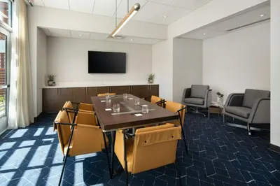 a conference room with a table and chairs and a tv at Courtyard by Marriott Fresno Clovis in Clovis