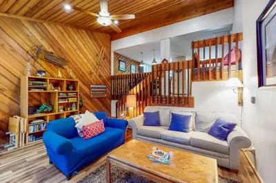 a living room with a couch and a table at Lake Therapy in Lakeshore