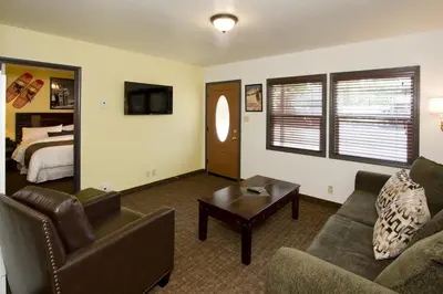 a living room with a couch and a bed at Holiday Haus in Mammoth Lakes