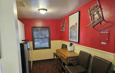 a dining room with red walls and a wooden table and chairs at Holiday Haus in Mammoth Lakes