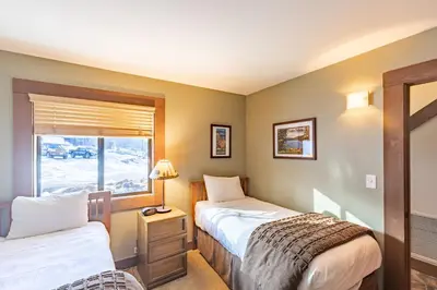 two beds in a room with a window at Cozy Aspen Grove 2 bed 2 bath condo in Truckee