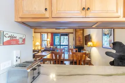 a kitchen and living room with a dining room at Cozy Aspen Grove 2 bed 2 bath condo in Truckee