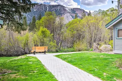 a wooden bench sitting on a walkway in a yard at Hot Tub Access Mammoth Lakes Nature Escape! in Mammoth Lakes