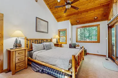 a bedroom with a bed and a ceiling fan at Seclusion in Style in Truckee