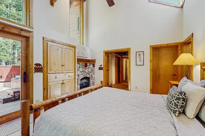 a bedroom with a large bed and a fireplace at Seclusion in Style in Truckee